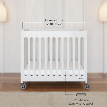 Foundations Boutique Folding Mini Baby Crib - Compact, Portable, Wooden Hotel Crib, Foldable Mini Crib for Baby & Toddlers - Includes 3" Foam Mattress, White