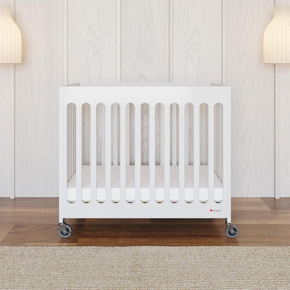 Foundations Boutique Folding Mini Baby Crib - Compact, Portable, Wooden Hotel Crib, Foldable Mini Crib for Baby & Toddlers - Includes 3" Foam Mattress, White